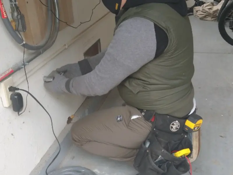 Electrician performing outlet wiring in a Naperville garage